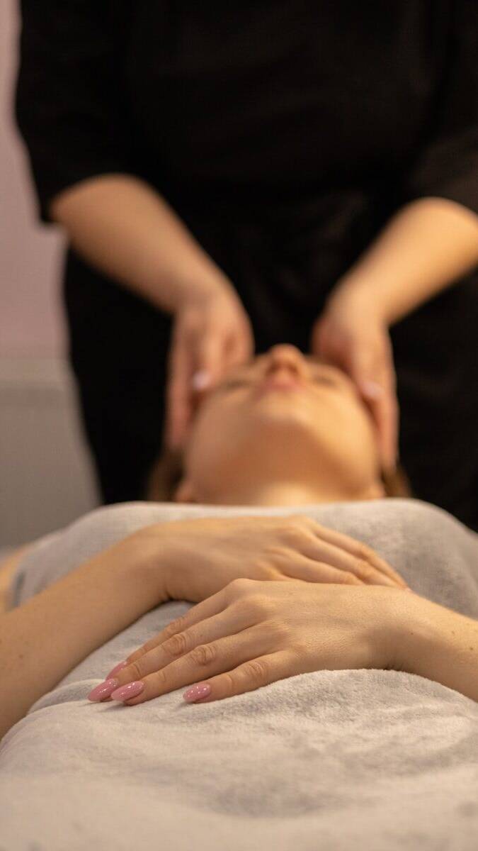 a woman getting a facial massage at a spa