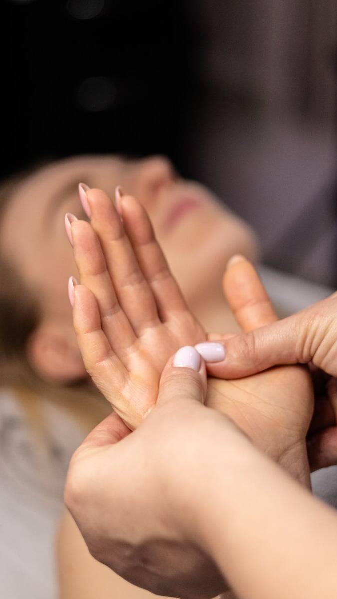 a woman laying on a bed with her hands together
